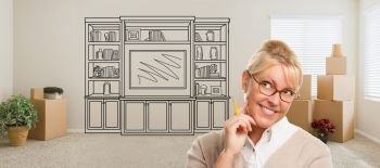 Woman Inside Room With Moving Boxes Glancing Toward Entertainment Unit Drawing on Wall.