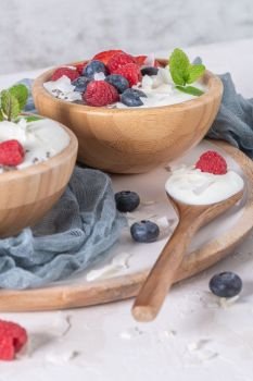 Yogurt and berries for healthy breakfast. Bowl of greek yogurt with raspberry, blueberries and strawberries