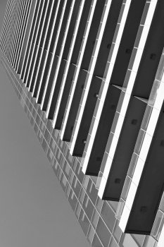 Perspective of many-storeyed apartment building. Black and white  architectural photography
