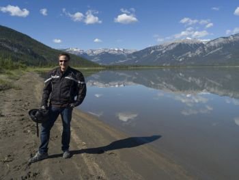 Tourist standing at lakeside, Jasper Lake, Yellowhead Highway, Jasper National Park, Jasper, Alberta, Canada