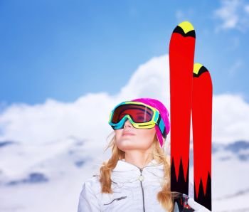 Closeup portrait of cute skier girl looking up on the sky, wearing special sportive mask, active lifestyle, enjoying winter vacation concept