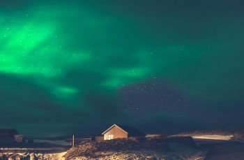Beautiful view on the Aurora Borealis, amazing green light on the night sky, wonderful nature of Iceland
