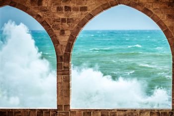 Beautiful sea view through amazing big arch windows of ancient building