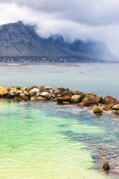 Amazing peaceful view on the Betty’s Bay, beautiful blue-green lagoon with clear water, mountains in the fog near shore, Atlantic Ocean, South Africa