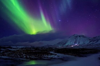 Iceland. Beautiful view on Aurora Borealis, amazing northern light in night sky, wonderful nature