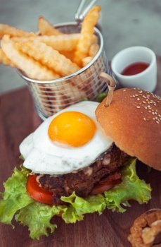 Burger with french fries, traditional american food, unhealthy nutrition