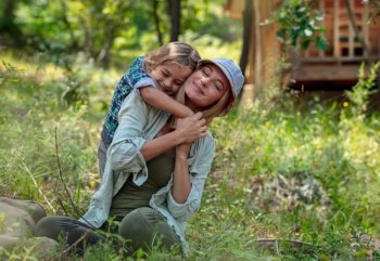 Portrait of a Happy Mother and Cute Little Son in the Forest. Family Having Fun. Summertime Active Vacation. Tight Hugs. Life is Beautiful.. Happy Family in the Forest