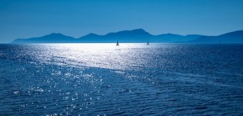 Beautiful sea view, sailboats far away in the sea in sunny day, natural background, amazing summer adventure, Mediterranean sea trip, peaceful Greece