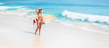 Sexy woman enjoying summer holidays on tropical resort, having fun on the beach, girl surfing in Bali, Indonesia, Asia