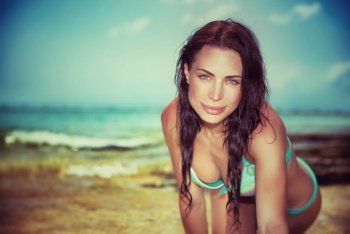 Vintage style portrait of beautiful brunet woman posing on the beach, beach fashion, summer vacation on tropical resort