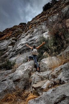 Active Sportive Woman Climbing the Mountains. Carefully Backpacker ?limbs Up to Tannourine Picks. Extreme Vacation in Lebanon.