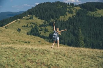Happy Active Traveler Girl Enjoying Time in Carpathian Mountains. Raised up Hands Having Fun. Summer Vacation. Travel Ukraine. Happy Active Life