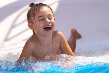 Portrait of a Cute Little Boy Having Fun in the Pool. Enjoying Water Park Slides on a Hot Summer Day. Beach Resort. Happy Active Holidays.. Happy Child in the Pool