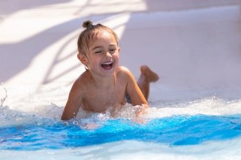 Portrait of a Cute Little Boy Having Fun in the Pool. Enjoying Water Park Slides on a Hot Summer Day. Beach Resort. Happy Active Holidays.. Happy Boy in Water Park