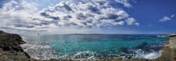 Panoramic view of lighthouse in Mediterranean sea off the coast of Menorca at Punta Prima