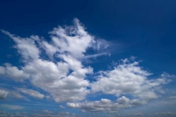 Blue sky with white summer cumulus clouds