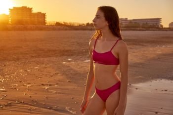 Bikini girl in the beach sand at summer Mediterranean