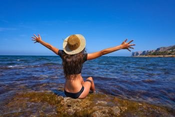 Bikini girl in summer Mediterranean beach having fun sit open arms excited