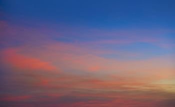Sunset clouds in orange and blue background