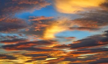 Sunset sky clouds in orange and blue background