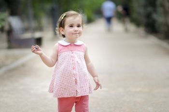 Adorable little girl playing in a urban park