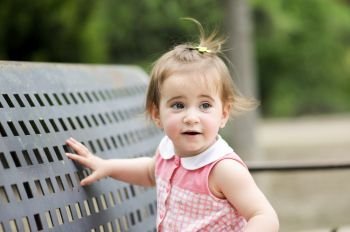 Adorable little girl playing in a urban park