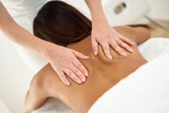 Arab woman receiving back massage in spa wellness center. Beauty and Aesthetic concepts.
