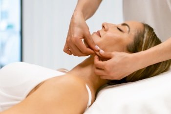 Middle-aged woman having a head massage in a beauty salon. Body care treatment in a beauty centre.. Middle-aged woman having a head massage in a beauty salon.