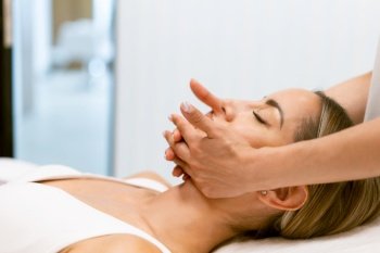 Middle-aged woman having a head massage in a beauty salon. Body care treatment in a beauty centre.. Middle-aged woman having a head massage in a beauty salon.