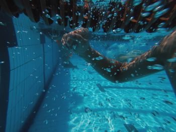 Boys hand underwater in swimming pool. Boys hand underwater