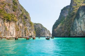 Panorama of famous Phi Phi island in Thailand with sea, boats and mountains in beautiful lagoon where the Beach movie was filmed