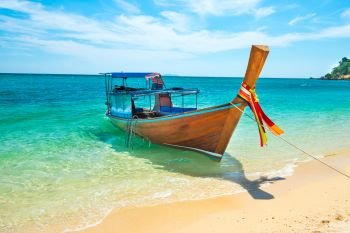 View of traditional thailand longtail boat at sand beach of tropical island in Andaman sea
