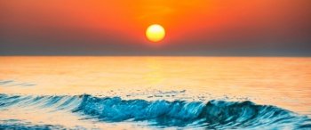 Sunset sea panorama, sun with sunset sea and wave