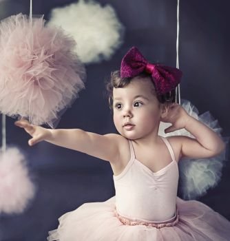 Portrait of a beautiful baby wearing a red polish ribbon