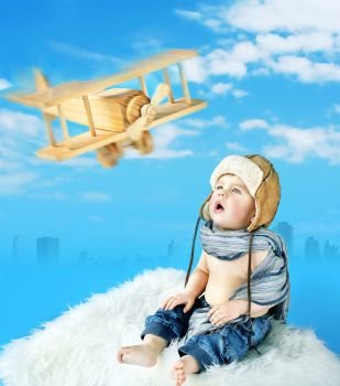 Little pilot looking at the toy aircraft