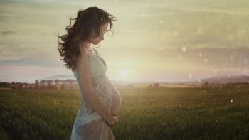 Beautiful pregnant lady in the wheat field