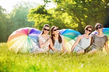 Four attractive ladies sitting on the fresh meadow