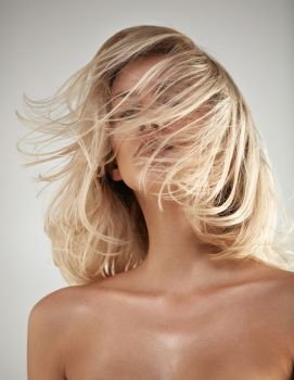 Fashion style portrait of a blond lady with tangled hair