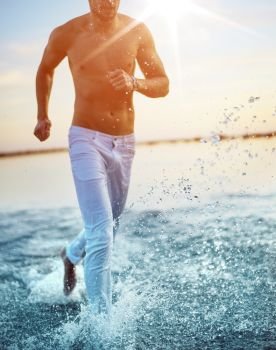 Summer shot of a guy running along the seaside