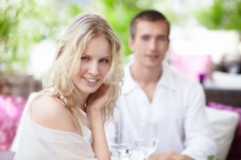 Young happy couple in a white restaurant