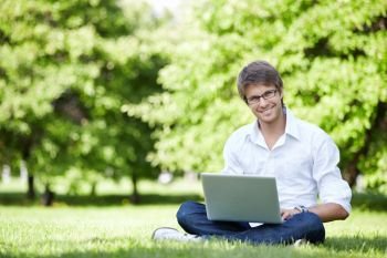A young man with laptop outdoor
