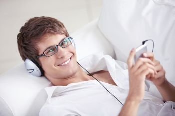 Smiling man listening to music on headphones