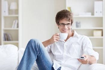 Young man with a cup at home