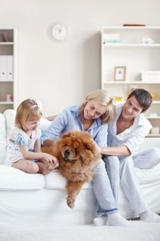 Smiling family with a dog indoors