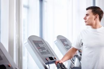 Young attractive man on a treadmill
