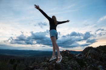 Travel, lesure and freedom concept - woman on the top of Altai mountain, beauty summer evening landcape. Travel, lesure and freedom concept