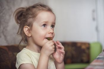 Little funny girl eats marmalade closeup portrait. Little funny girl eats marmalade
