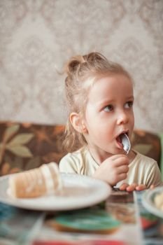 Little funny girl eats ice cream. Ice-cream and little girl