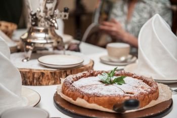 Apples pie with samovar on the served table. Apples pie with samovar
