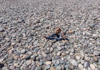 Aerial view of Katun stones riverbank, in Altai mountains, woman lying on the stones in beauty day.. Aerial view of Katun river